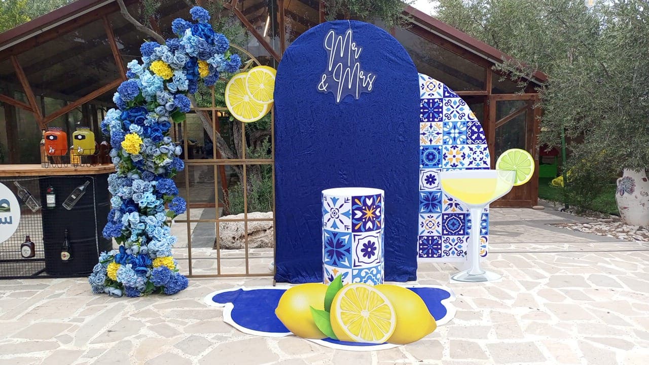 Blue floral arch with a neon Mr and Mrs sign